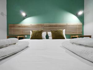 a large bed with white sheets and pillows at Cosy room 4 in Pieta