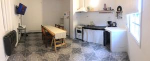 a small kitchen with a table and a stove top oven at Espacio Marea in Puerto Madryn