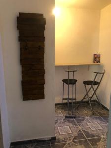 a room with two bar stools and a table at Espacio Marea in Puerto Madryn