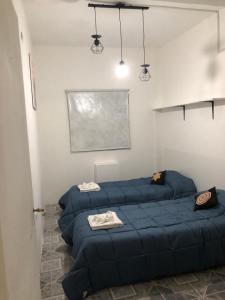 a room with three blue beds in a room at Espacio Marea in Puerto Madryn