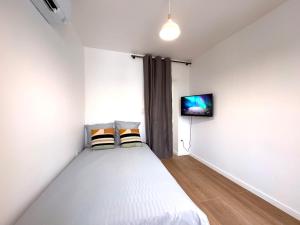 a bedroom with a bed and a tv on the wall at Le Chenin 2 Pers Proche gare Avon in Avon