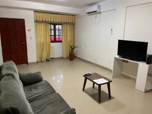 a living room with a couch and a tv at Casa balcarce in Salta