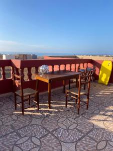 a table and chairs sitting on top of a roof at Ahmed mirleft in Sidi Ifni