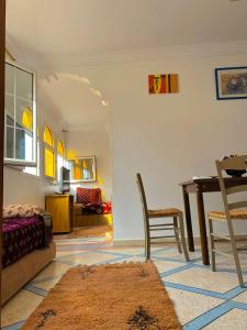 a living room with a table and a dining room at Ahmed mirleft in Sidi Ifni