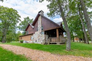 a log home with a wrap around porch at WISPer by Railey Vacations in McHenry