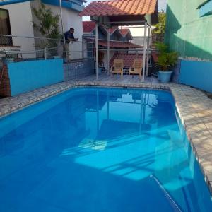 a large swimming pool with blue water at Hotel La Uvita in Puerto Limón