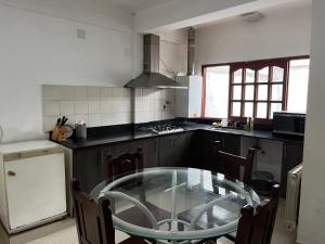 a kitchen with a glass table in a kitchen at Casa balcarce in Salta