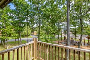 a wooden deck with a bench and a picnic table at WISPer by Railey Vacations in McHenry