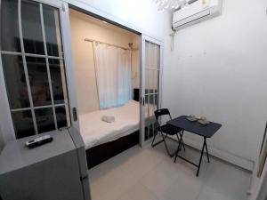 a small room with a small bed and a table at bnb's in Hong Kong