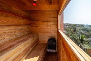 an empty wooden sauna with a large window at Casa Toro La Punta in Puerto Escondido