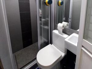 a bathroom with a toilet and a shower and a sink at bnb's in Hong Kong