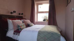a bedroom with a bed and a window at Durrus in Durrus
