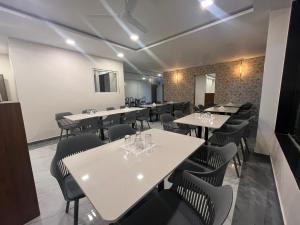 a restaurant with tables and chairs in a room at Gugal Bliss in Mahabaleshwar +50 photos