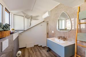 a bathroom with a sink and a staircase at Mansarda in pieno centro in Savona +24 photos