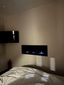 a bedroom with two monitors on the wall at The Cozy Residence in Veria