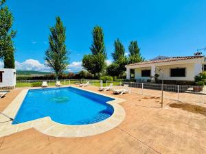 a swimming pool in front of a house at Dehesa La Parrilla - VUT- Eventos in Pepino