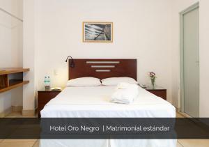 a bedroom with a large bed with white sheets at Hotel Oro Negro in Talara +44 photos