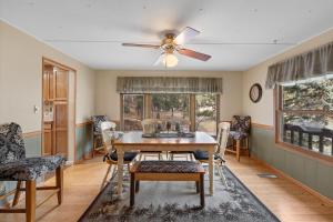 a dining room with a ceiling fan and a table and chairs at Prairie Creek Cabin Getaway in Rapid City