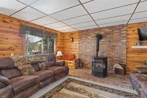 a living room with a couch and a fireplace at Prairie Creek Cabin Getaway in Rapid City