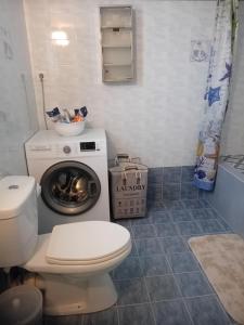 a bathroom with a toilet and a washing machine at Ligeia Bedrooms Nafplio in Nafplio +42 photos
