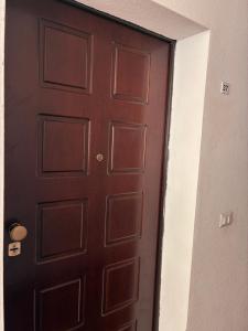 a brown door in a room with a white wall at Casa Nietta in Olbia +8 photos
