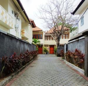 a cobblestone street in front of a house at Villa Ngetis in Sanur