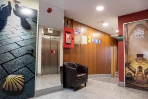 a waiting room with a chair in a building at Hotel Cardeña by gaiarooms in Burgos