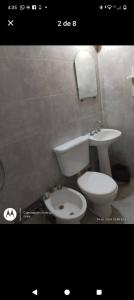 a bathroom with a toilet and a sink at Elu in Ingeniero Giagnoni