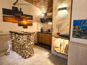 a kitchen with a pile of fire wood next to a counter at Suite Mediterraneo in Civitavecchia