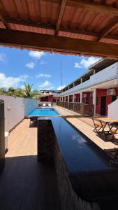 a swimming pool on the side of a building at Pousada Manancial in Itaúnas