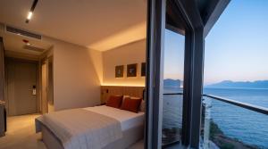 a bedroom with a bed and a view of the ocean at Reev Coffee House in Antalya