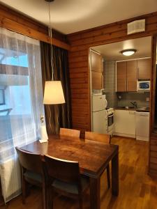 a kitchen and dining room with a table and chairs at Chalet Ylläs C413 included bed linen and towels in Ylläs