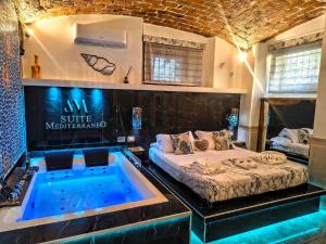 a room with a bed and a bath tub at Suite Mediterraneo in Civitavecchia