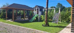 a playground with a slide and a gazebo at Siedlisko TomaszEwka in Bobowa