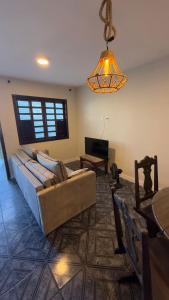 a living room with a couch and a table at Casa maricota in Porto Seguro