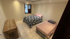 a room with two twin beds and a window at Casa maricota in Porto Seguro +16 photos