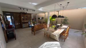 a living room with a dining table and chairs at Casa maricota in Porto Seguro