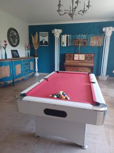 a pool table in a living room with at Maison Sol Air in Montazels