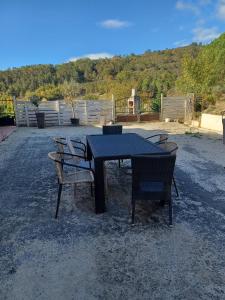 a black table with chairs sitting around it at Maison Sol Air in Montazels