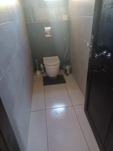 a small bathroom with a toilet and a tiled floor at Maison Sol Air in Montazels +14 photos