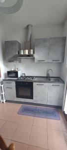 a kitchen with a sink and a stove at La casetta di Marilena in Bindo