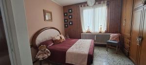 a bedroom with a bed and a window at La casetta di Marilena in Bindo