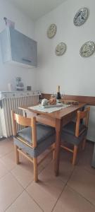 a wooden table and two chairs sitting around a table at La casetta di Marilena in Bindo +9 photos