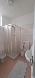 a bathroom with a shower and a tub and a toilet at La casetta di Marilena in Bindo