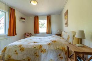 a bedroom with a bed and a table and a window at HAL819-Unnaryd-Soedra-vaegen-29-b in Unnaryd