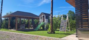 a playground with a slide and a gazebo at Siedlisko TomaszEwka in Bobowa