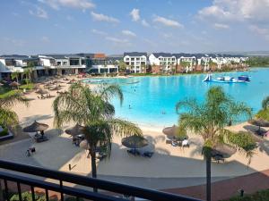 a view of a large swimming pool in a resort at Spectacular Lagoon Facing Apartment - The Blyde in Pretoria