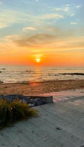 a sunset on the beach with the sun setting at Ploy Chumpoo Kantiang in Ko Lanta