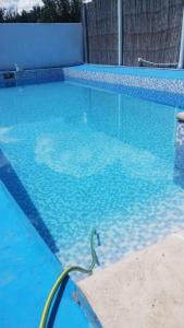 a swimming pool with a hose in the water at Elu in Ingeniero Giagnoni