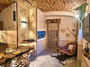 a bathroom with a stone fireplace and a chair in it at Suite Mediterraneo in Civitavecchia +19 photos